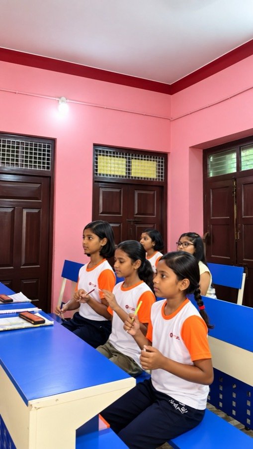 Girls following an abacus lesson in a Mastermind Abacus classroom