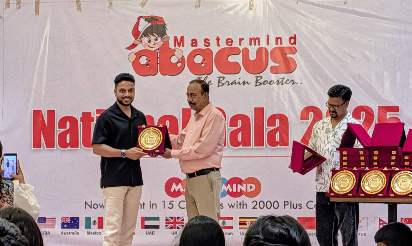 Mastermind Abacus Odisha being felicitated with a gold plaque on stage at the Mastermind National Gala 2025