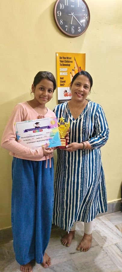 Student with drawing competition trophy and certificate