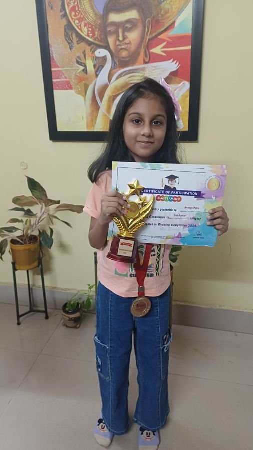 Young girl proudly holding her abacus participation certificate, trophy and medal
